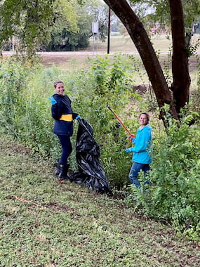 TCU students holding trash pickers and trash bags