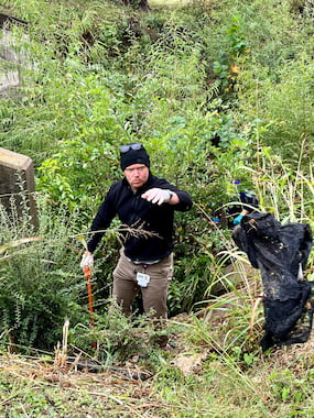 TCU community member picking up trash