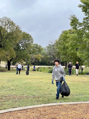 TCU community member picking up trash