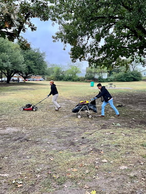 TCU community members mowing Glenwood Park's grass