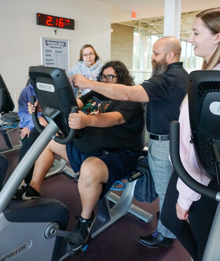 Dr. Esposito working with students and a participant