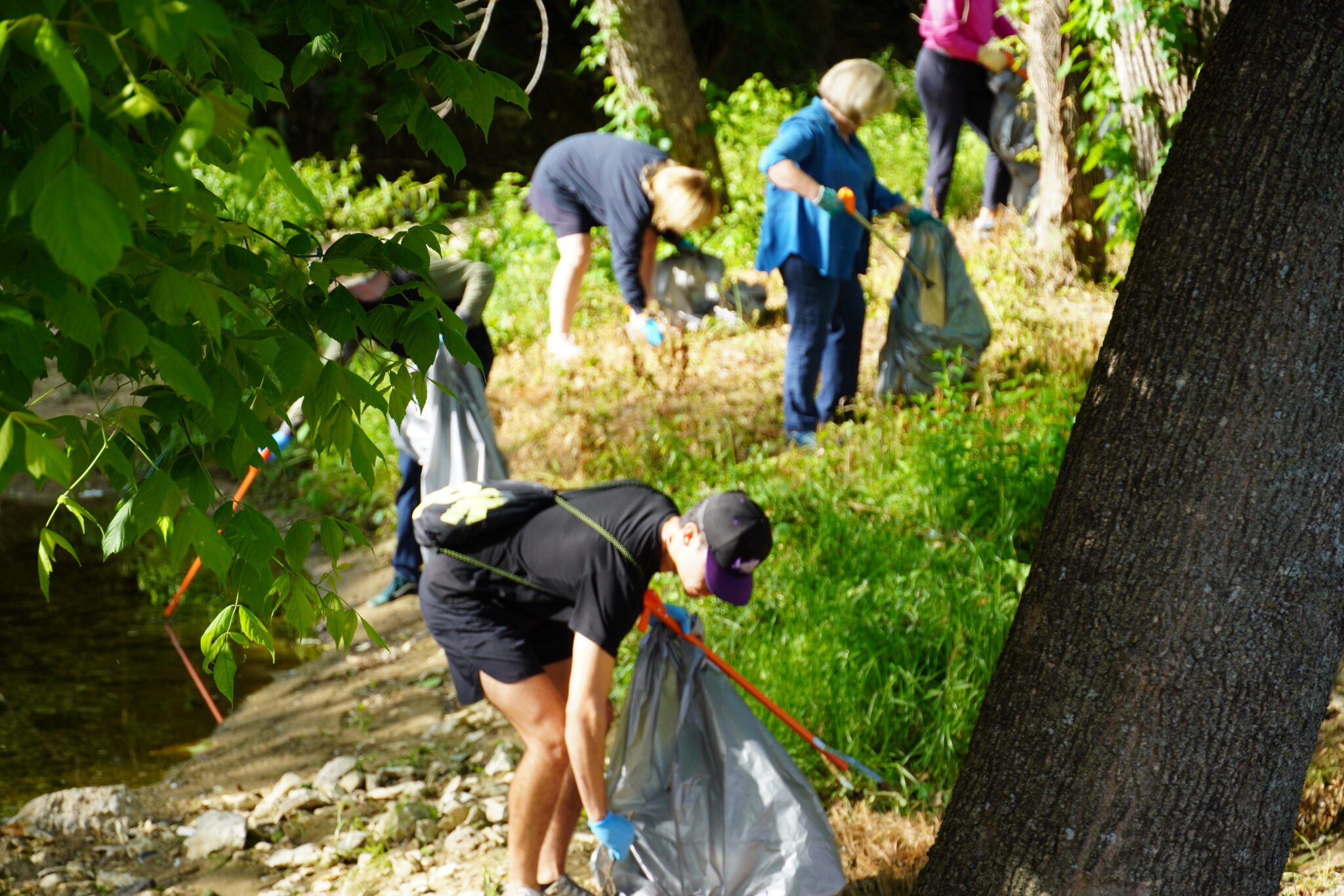 TCU community picking up trash with their respective tools and gloves