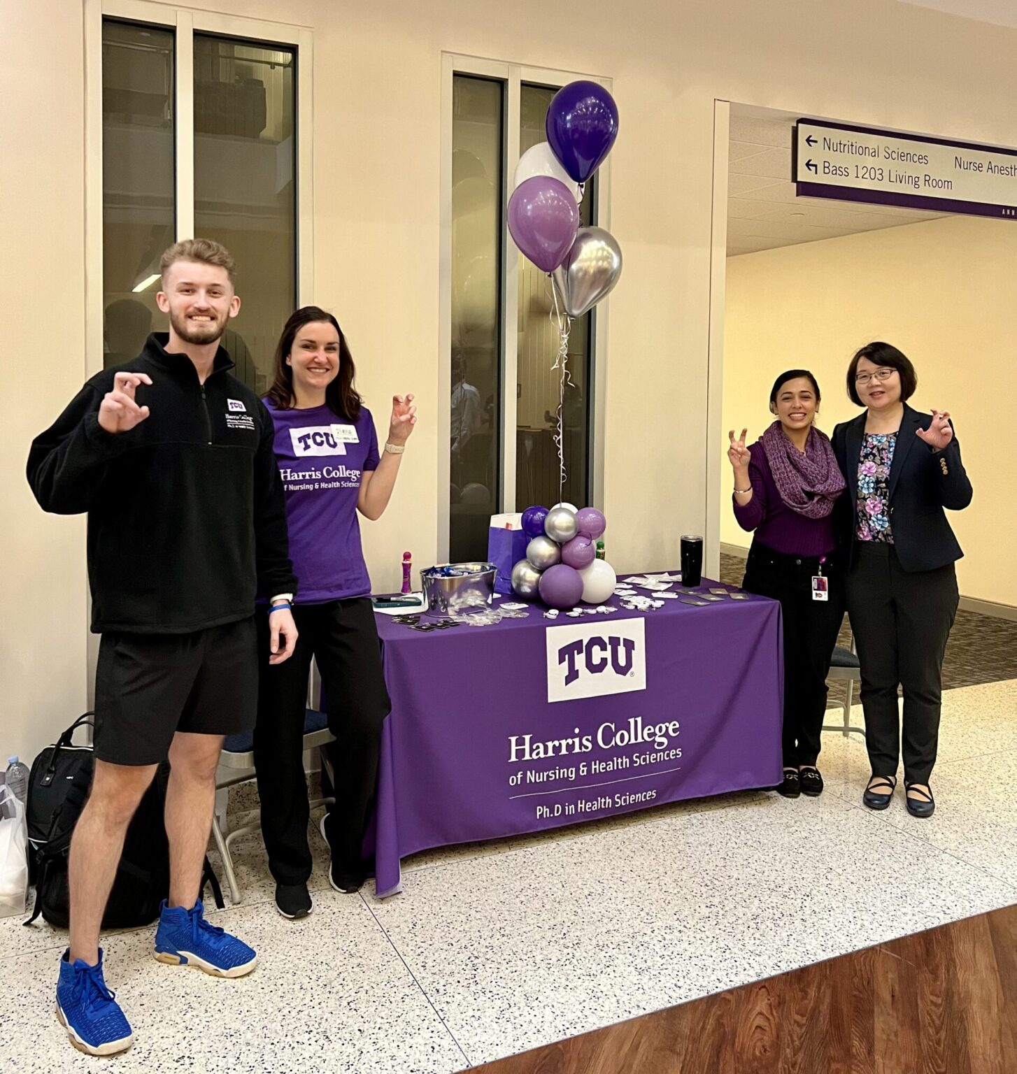 Members of the Health and Sciences program in front of a table booth