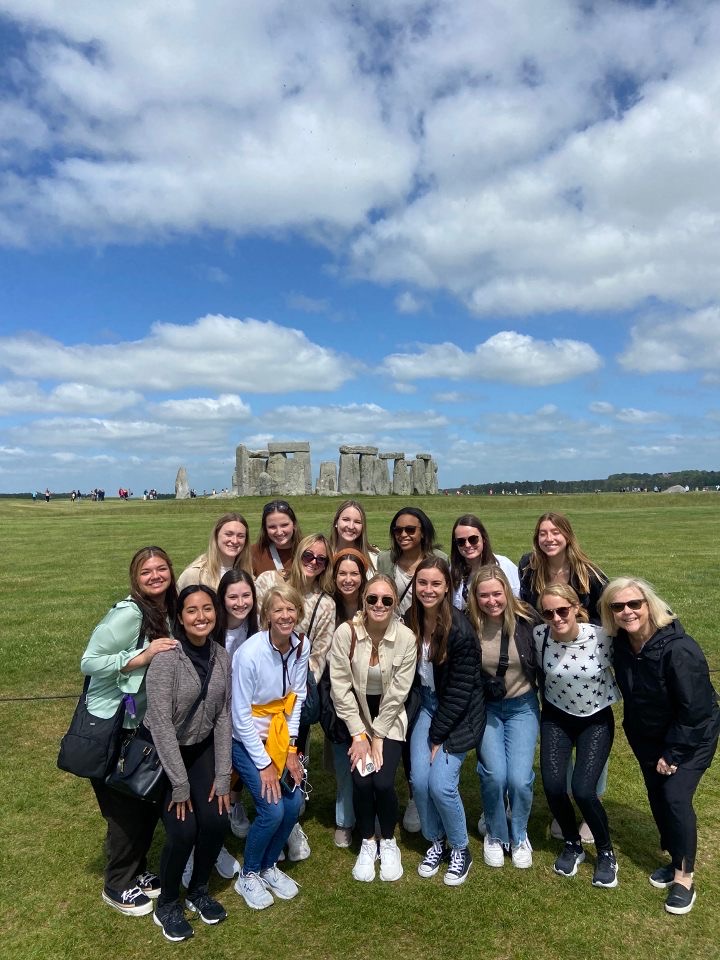 Kyndal and other TCU students posing in front of the Stonehenge Monument