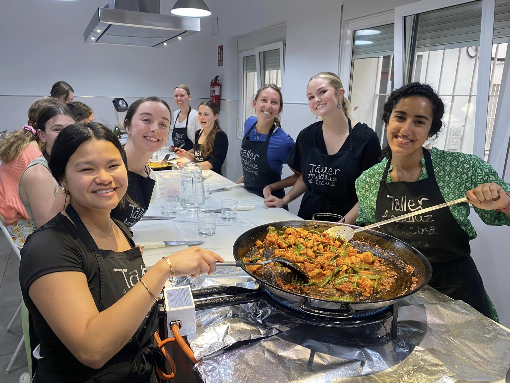 students displaying the food they cooked