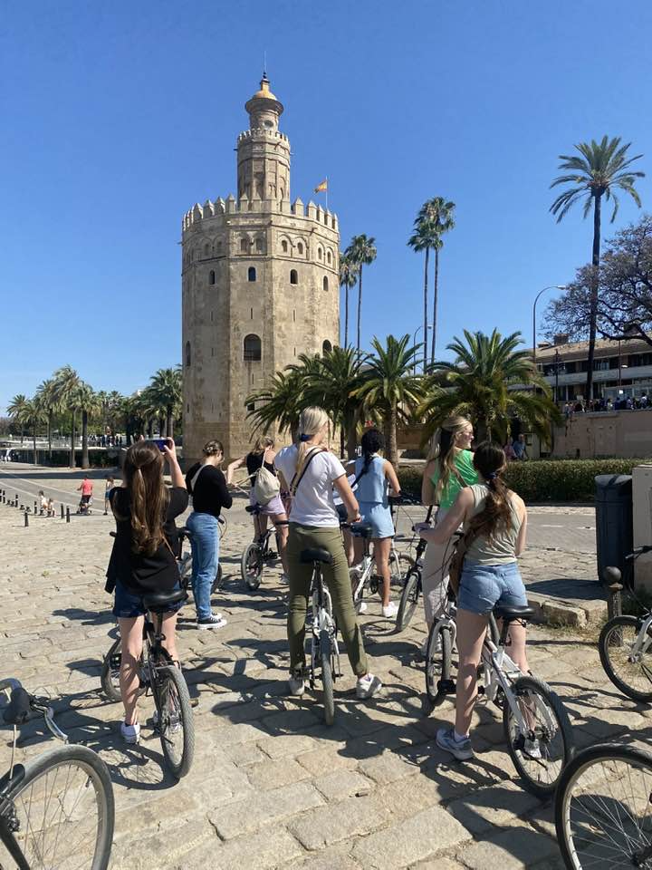 Students are on bikes taking pictures of the city