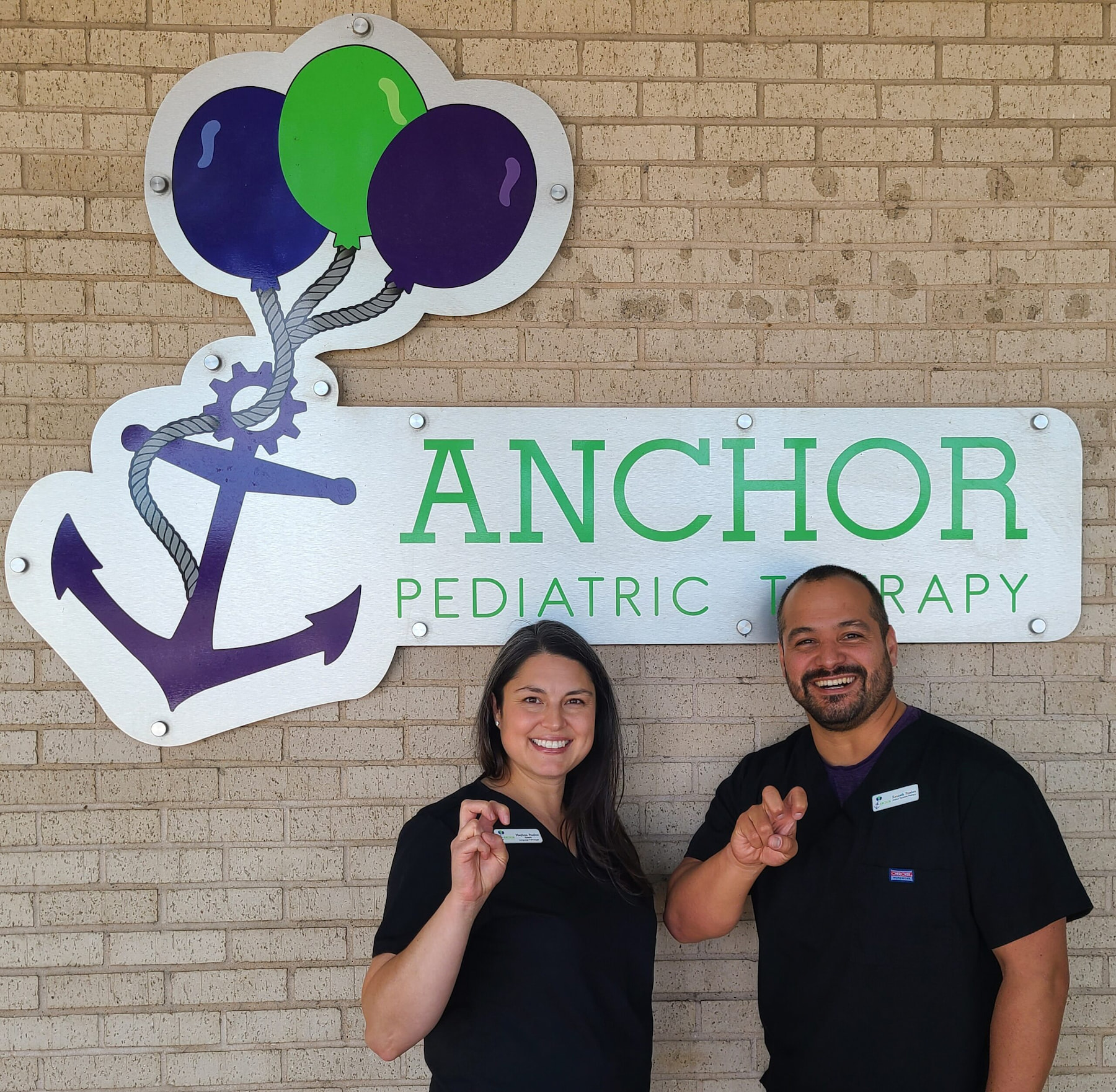 Meghan Ruelas ’07 MS, CCC-SLP and Kenneth Ruelas ’07 (’22 MBA) pose in front of their pediatric rehabilitation clinic, Anchor Pediatric Therapy, established in 2012 in Fort Worth, Texas. Photo provided by Meghan Ruelas.