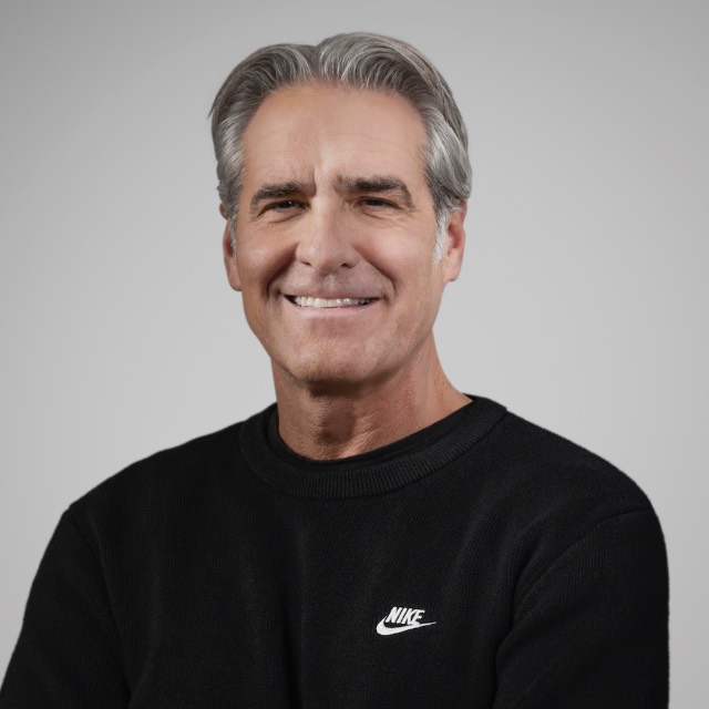 Elliott Hill '86, wearing a black t-shirt with a white Nike logo on it