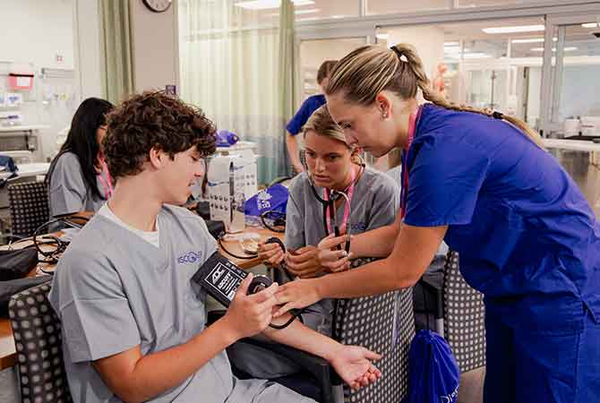 TCU Nursing student teaching high school students